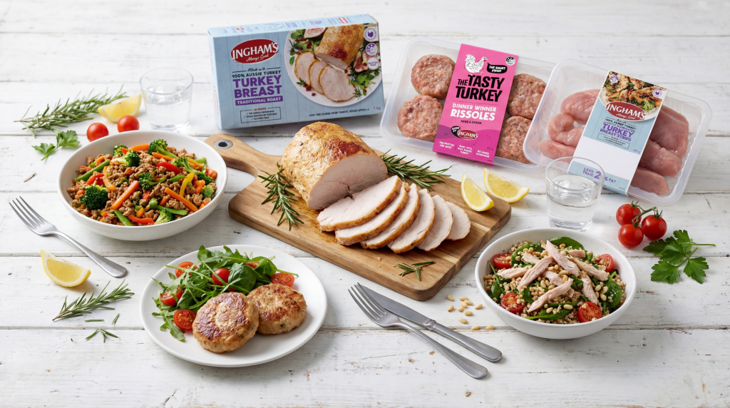 Ingham's Tasty Turkey range including rissoles, burgers and breast steaks displayed with freshly prepared meals on a white timber table